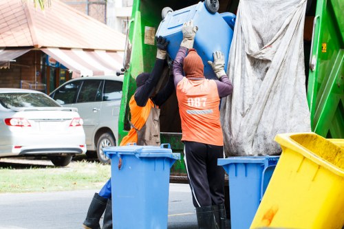 Clearance professionals removing large furniture from a home.